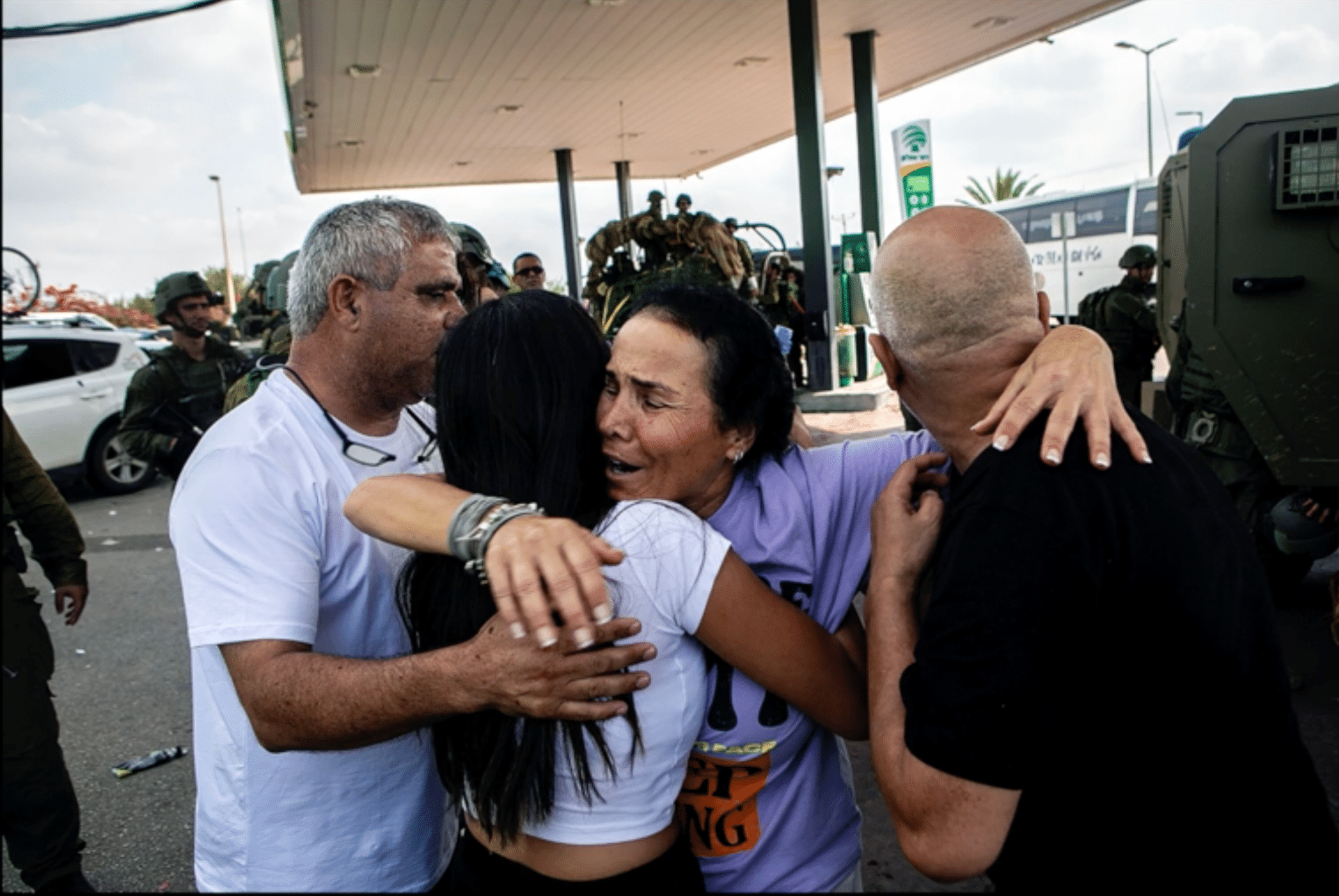 A group of people embrace each other