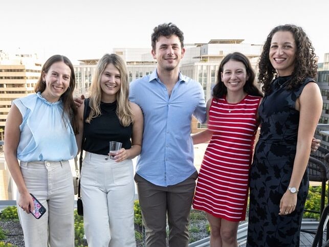 Five people standing on a rooftop