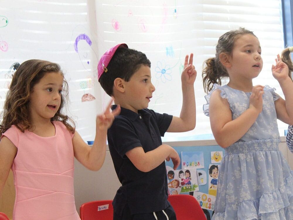 Three preschool children in a classroom
