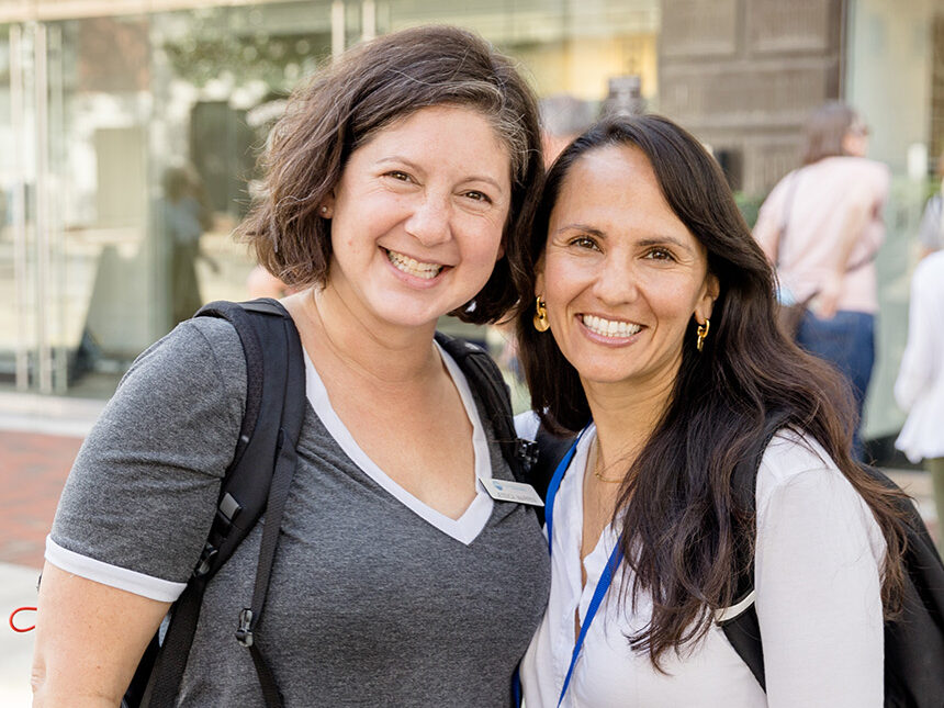 Two Federation employees pose and smile for the camera.