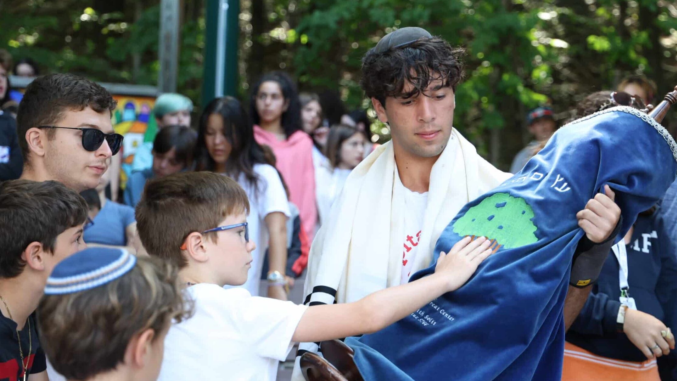 Campers hold a torah.