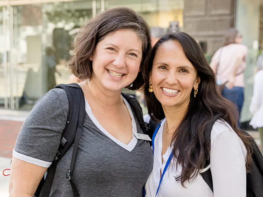 Two Federation employees pose and smile for the camera.